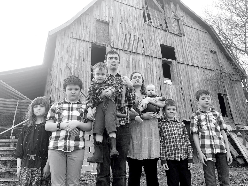 Family old-time photo outside barn